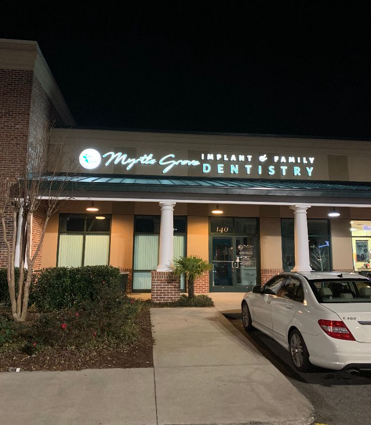 Car parked in front of the Myrtle Grove Implant & Family Dentistry office in Wilmington, NC