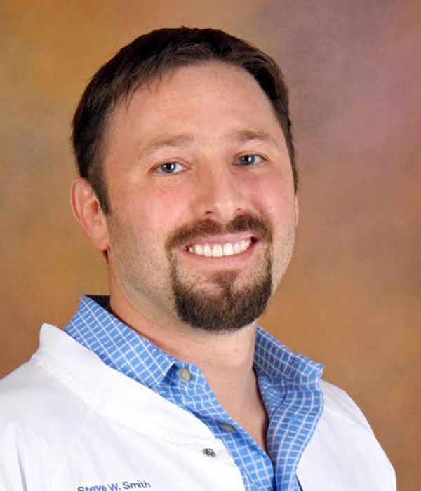 Dr. Dakota James Peachee wearing a white lab coat at Myrtle Grove Implant & Family Dentistry in Wilmington, NC