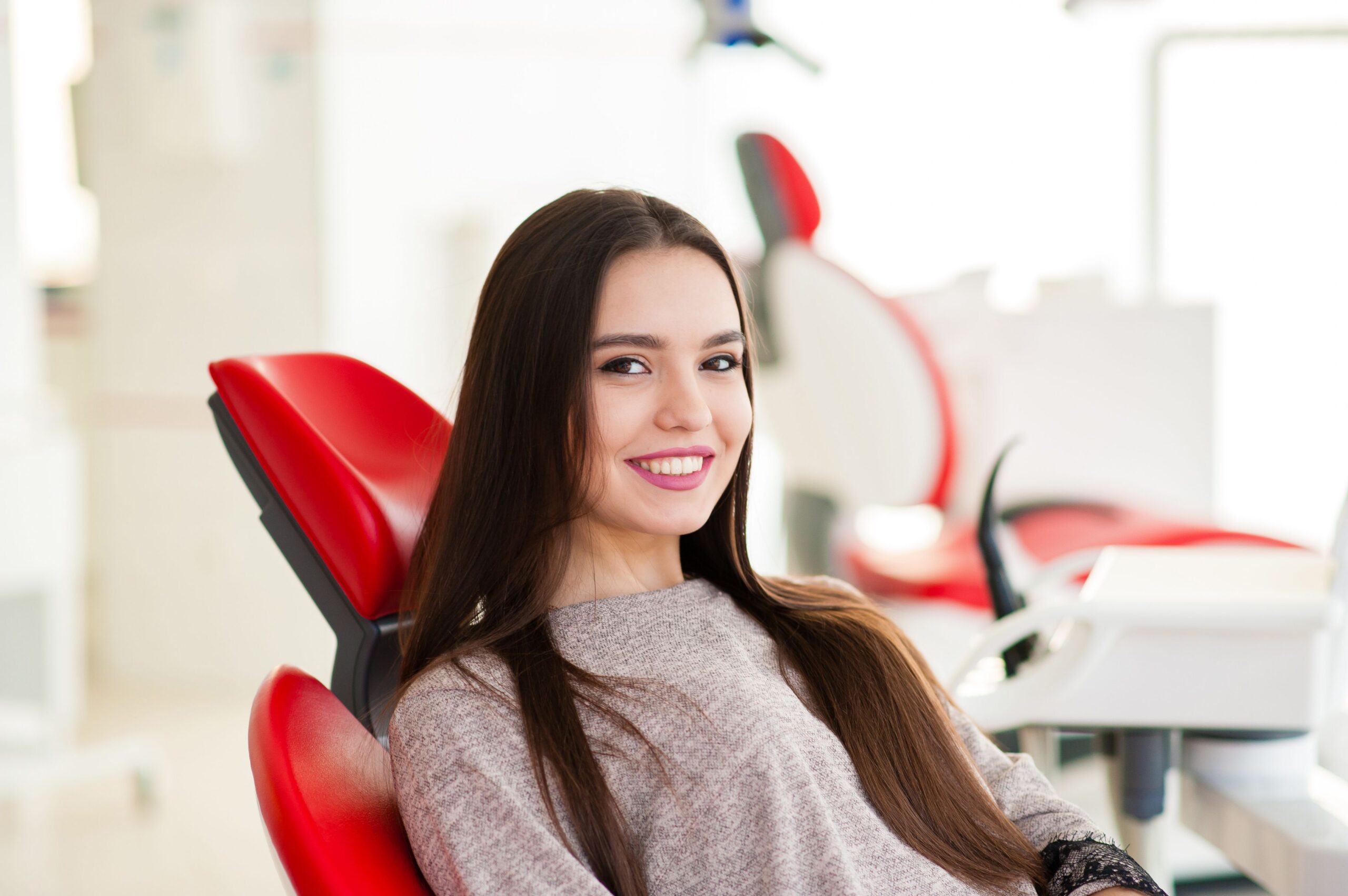 Smiling patient sitting in the dental chair at Myrtle Grove Implant & Family Dentistry in Wilmington, NC